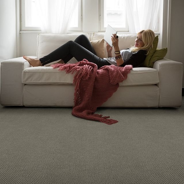 A woman is reading something from Family Floors Furniture in Brandon