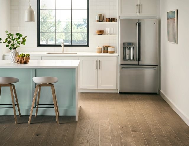 large modern kitchen with white bar top and bar stools from Family Floors Furniture in Brandon